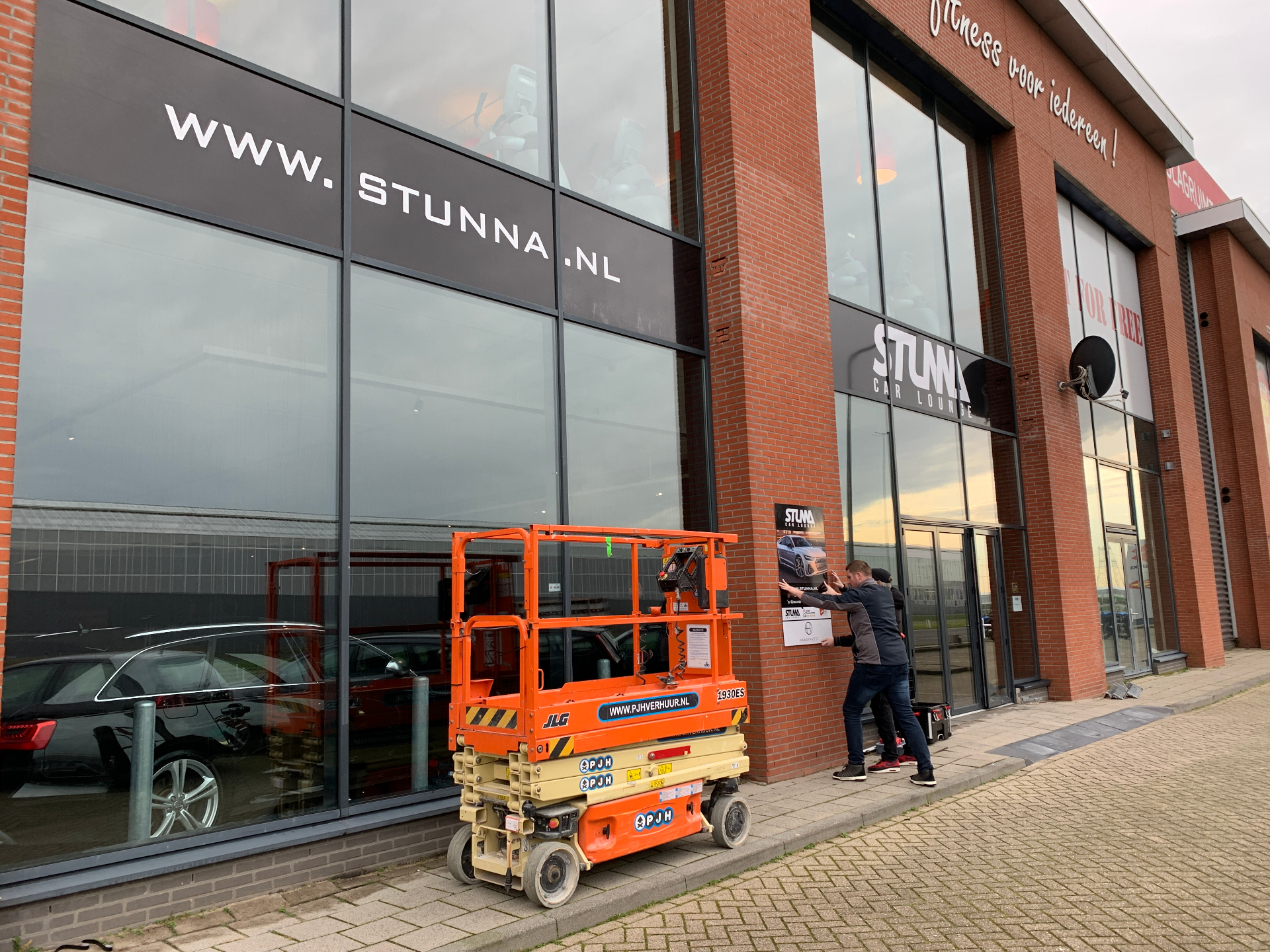 Plaatsen van de www.stunna.nl-belettering op de gevel.